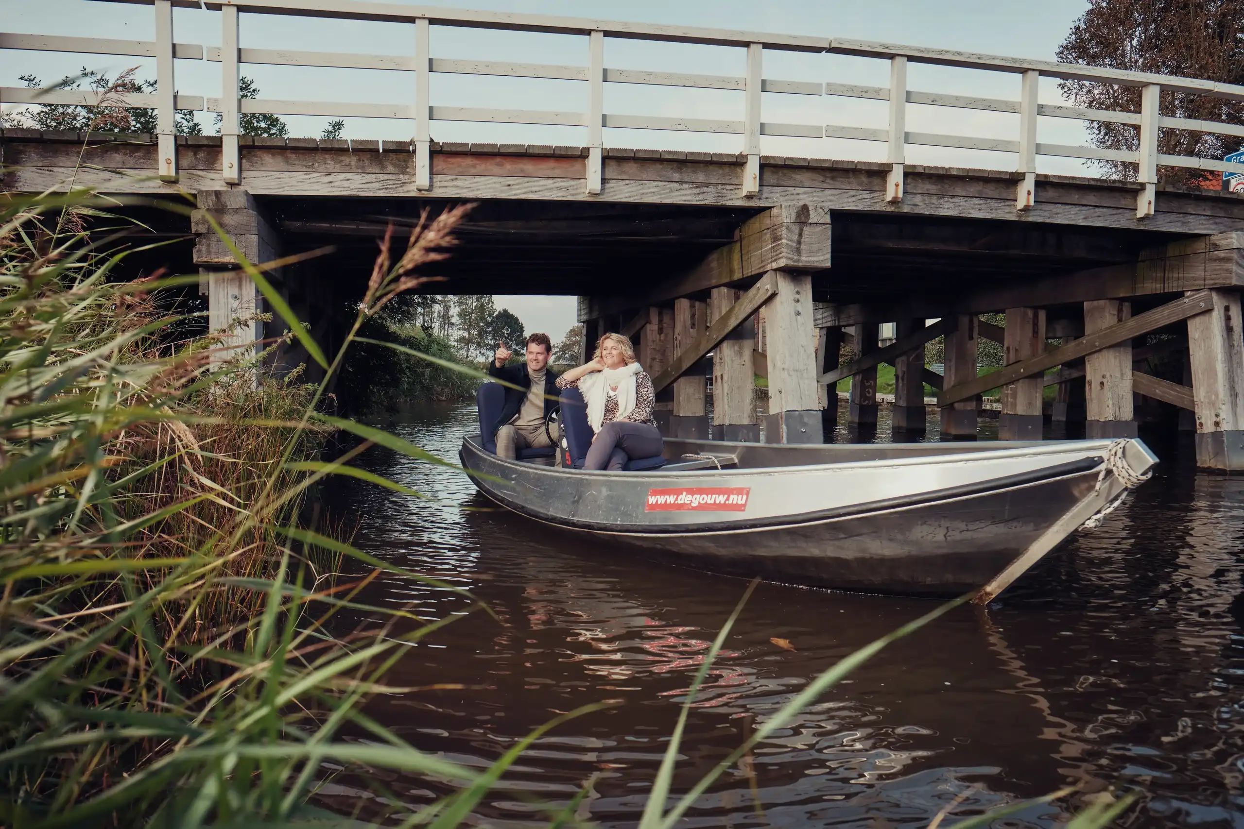 Fluisterbootje onder een houten brug